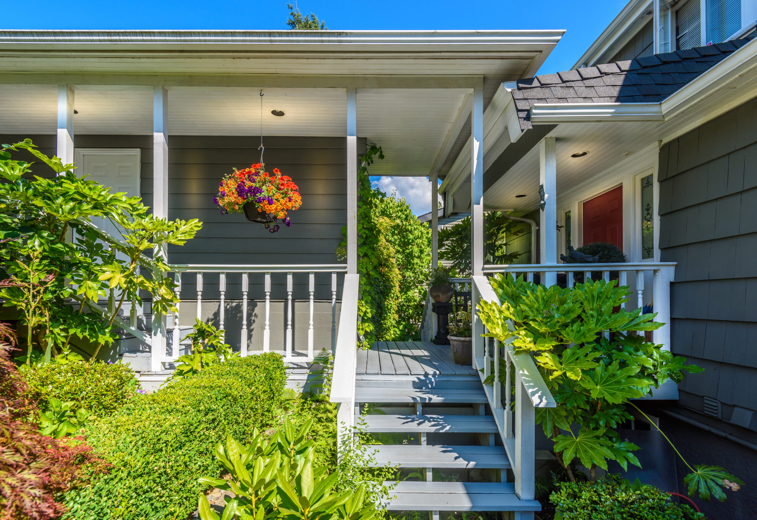 Front porch of a house with lots of flowers